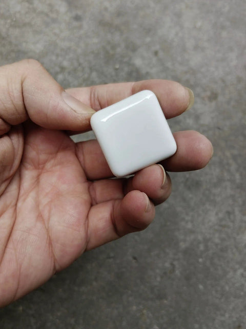 Hand holding 1.25 Inch Glossy Ceramic Square Cabinet Knob White; part of a 6 Pcs set, easy install drawer pull handle for kitchen or dresser.