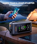 8-In-1 Car Jump Starter With Air Compressor And Tire Inflator, 4500A Peak on a table charging a smartphone