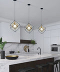 Four Light Black Farmhouse Chandelier With Adjustable Metal Cage over kitchen island