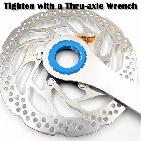 Centerlock Lockring For 12mm, 15mm, And 20mm Thru Axles And Quick Release on disc rotor with wrench shown