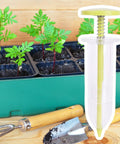 Go To Seed Spreader And Sowing Tool For Gardeners with ergonomic design, shown beside young seedlings and garden tools in a tray.