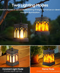 Must Have 4 Pack Dancing Flame Solar Lanterns Outdoor Waterproof With Upgraded Flickering Flame And Constant Modes hanging on a tree branch.