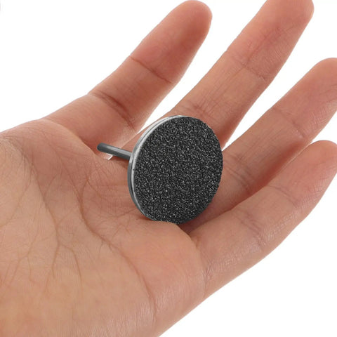 Portable Nail Care Kit With 80 150 240 Grit Sandpaper Discs For Dead Skin Removal, Foot File Sanding Sheets, Grab And Go Travel Friendly Nail And Foot Grooming Set For Home Or On The Go. single black sanding disc held in hand