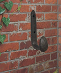 Four Pack Badass Cast Iron Wall Hooks In Rustic Black Vintage Coat Rack Heavy Duty Entryway Storage Organizer With Pre Drilled Screws For Jackets Bags And Everyday Gear on brick wall