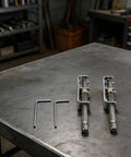 Super Cool Spring Loaded Screwdriver Bit Extension With Non Magnetic Grip For Slotted And Phillips Torx Bits In Silver. This One-Handed Pro Repair Tool Is A Total Game Changer For Fastening Jobs And Keeps Fasteners Secure While You Work Hard On Any Tough. silver metal bit extensions with hex keys on workbench