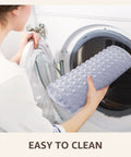 Big Time Grip Non Slip Bathtub Shower Mat features heavy duty suction cups being placed in a washing machine for easy cleaning.
