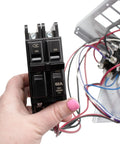 Hand holding circuit breaker, part of the 10 kW Electric Heater Kit With Circuit Breaker For HVAC Air Handler, Plug And Play High Output Heating Upgrade, 240V 60Hz, 39.6 A, Alloy Open Coil, Includes Limit Controls, Fits Specific Air Handler Models. Electric wiring in background.