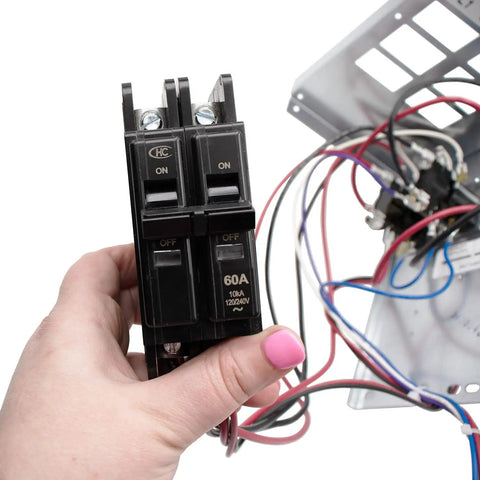 Hand holding circuit breaker, part of the 10 kW Electric Heater Kit With Circuit Breaker For HVAC Air Handler, Plug And Play High Output Heating Upgrade, 240V 60Hz, 39.6 A, Alloy Open Coil, Includes Limit Controls, Fits Specific Air Handler Models. Electric wiring in background.