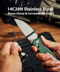 Rockshark EDC Folding Pocket Knife With 3.03 Inch 14C28N Drop Point Blade Green Micarta Handle in hand on wood table