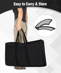 Person carrying 35 Inch Portable Fire Pit Surround Tabletop Round Shield in black bag, showcasing easy transport.