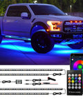 Truck with Lit Under Car LED Underglow Kit With App Control And Remote 16 Million RGB Colors, strips and remote in view.