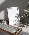 Slick Wooden Sunglasses Display Tray With Soft Gray Velvet Lining Seven Grid Eyewear Organizing Rack with sunglasses on desk.