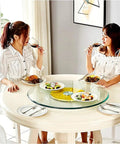 Two women dining with a Round Glass Serving Turntable 70-120cm Rotating Tray For Dining Tables in use