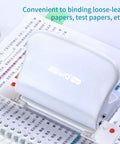 10 Hole Paper Punch Handheld Metal Puncher on open notebook, ideal for A4 A5 B5 notebooks and scrapbooks, 10 sheet capacity