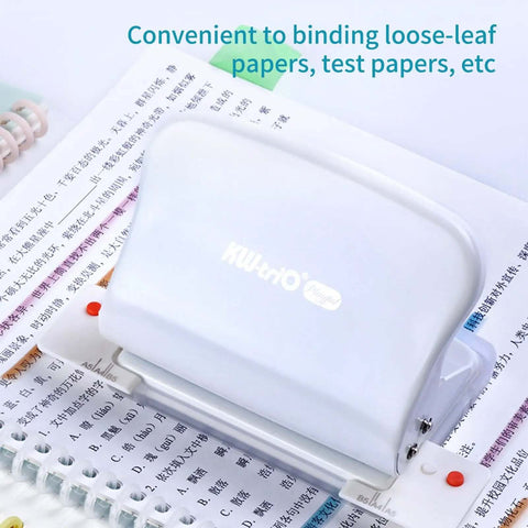 10 Hole Paper Punch Handheld Metal Puncher on open notebook, ideal for A4 A5 B5 notebooks and scrapbooks, 10 sheet capacity