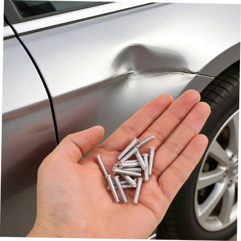 Hand holding silver 4mm metal pulling pins from Top Picks For Car Body Repair Welding Studs 50 Pack for dent removal.