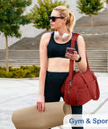 Woman holding Maroon Lightweight Travel Duffel Bag For Women With Wet Pocket And Luggage Sleeve Puffer Gym Tote outdoors