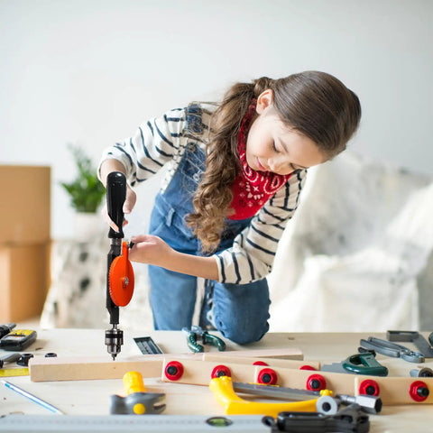 Child using One Quarter Inch Capacity Manual Hand Drill Kit With Ten Drill Bits on a wooden board for DIY model making