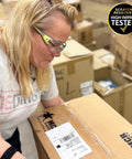 Woman using Premium Lightweight Frameless Safety Glasses with Killer Antifog Lens while working in a warehouse setting.