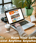 Person working on a laptop with a Leak-Proof 12 Oz Coffee Cup With Lid And Sleeve next to them on a wooden table.