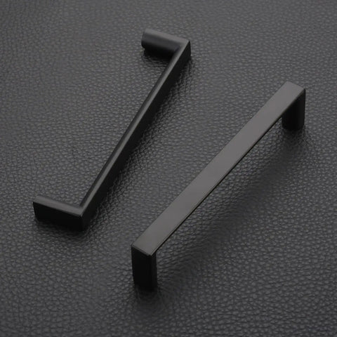 Sleek Five Inch Matte Black Cabinet Handles And Drawer Pulls For A Total Kitchen Glow Up With Solid Zinc Alloy Construction And 128 mm Center Spacing Fits Dressers Cupboards And Wardrobes Perfectly Includes Ten Pieces shown in profile on textured background.
