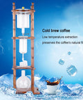 Slick Cold Brew Coffee Tower Featuring A Reliable Ice Drip System For Bold Flavor Kick Holds A Humongous 3000ML Glass Jar Settled On A Raw Brown Wood Stand Perfect For Patio Hangouts Or Friday Night House Vibes.