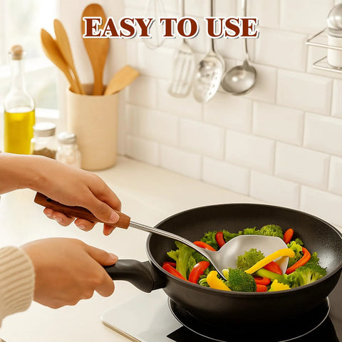 Wok spatula with stainless steel blade and wooden handle, side view used to stir-fry vegetables in a pan