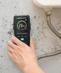 Pinless Moisture Meter For Walls And Wood, Non Destructive Surface Scanner With Fast Accurate Readings On Concrete, Drywall And Lumber, Diy Friendly Tool That Will Not Damage Surfaces, Stable Sensor For Reliable Moisture Levels. Handheld moisture meter reading 23.4% on moldy wall near sink.