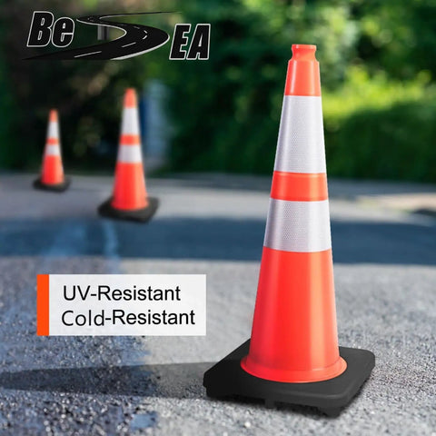 Eight 28 Inch Orange PVC Traffic Cones With Black Base standing on pavement, emphasizing durability and weather resistance.