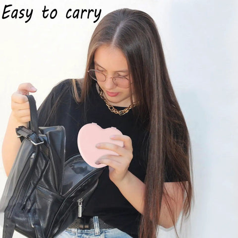 Woman holding Heart Shaped Portable Travel Sewing Kit For On The Go Fixes Mini Box With Threads Scissors Hand Sewing Needles