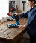 Person using Angle Grind Stand With Guard For Precise 45 Degree Cuts, on a wooden workbench in a workshop setting.