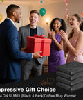 Keep Your Coffee Tea And Cocoa Toasty With This Slick Black Four Pack Electric Cup Heater Boasting Three Custom Heat Levels And A Universal Mug Fit That Slides Right Into Every Office Or Home, shown as a gift.