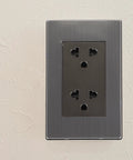 Heavy Duty Stainless Steel Wall Outlet Extender Plate With Circular SixSocket Configuration And Smart Usb ChargingPorts ForHome&OfficePowermanagement&ClutterFreeDecor on light textured wall.