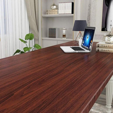 Slick Peel And Stick Countertop Wrap Featuring Sweet Dark Walnut Wood Grain waterproof vinyl on a desk with laptop.
