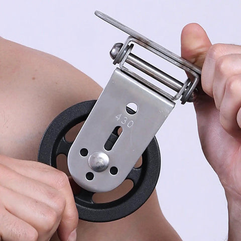 Heavy Duty Gym Pulley System With Wall Mount Single Pulley Block showing metal construction and black wheel in hand