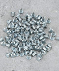Heavy Duty Non Slip Tire Studs For Cars Trucks Atvs And Motorcycles With Built Different Tungsten Steel Core For Ice Snow And Mud Traction 100 Piece Pack Road Grip scattered on a gray surface