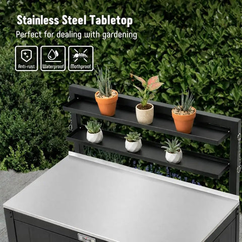 Outdoor Potting Bench With Storage Cabinet And Stainless Steel Work Surface Garden Workstation Raised Edge Top Adjustable Shelf And Removable Hutch For Patio Balcony And Outdoor Workspace Black, showing stainless tabletop and potted plants.