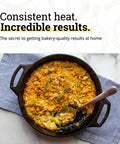 Baked dish in Seasoned Cast Iron Baker’s Skillet With Dual Handles Your Go-To Bakeware For Oven Ready Desserts Roasting And Everyday Cooking 10.25 Inch Heavy Duty Pan Built To Last And Create Even Heating For Perfect Bakes, served on striped cloth.