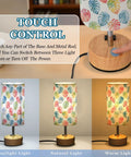 Watercolor Monstera Leaf Palm Decor Bedside Lamp with dimmable touch control and charging station displayed with light settings.