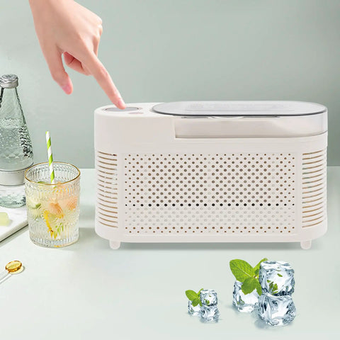 Fast Freeze Mini Countertop Ice Maker Features A Clear Viewing Lid While You Watch Crisp White Cubes Drop Right Out on a table.