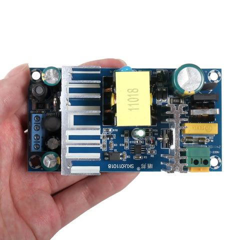 Hand holding Dual Output Industrial Power Supply Module 24V 4A and 12V 1A Isolated, Wide Input 100-260V AC 50/60Hz, 100W Max