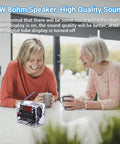 Two women laughing at kitchen table with DIY FM Radio Kit For Learning And DIY Soldering Practice 87 To 108MHz module visible.