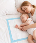 Heavy Duty Disposable Bed Pads Extra Large Underpads 50 Pack Super Absorbent Leak Proof Chux Style Pads For Adults Pets And Elders 30By36 Inch Blue Total No Sweat Solution, used under a baby and mother.