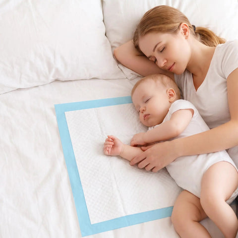 Heavy Duty Disposable Bed Pads Extra Large Underpads 50 Pack Super Absorbent Leak Proof Chux Style Pads For Adults Pets And Elders 30By36 Inch Blue Total No Sweat Solution, used under a baby and mother.