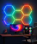 Lit RGB Hexagon Garage Light Kit With 5 Panels, 25 Pack Color Changing LED Lights installed on wall above gaming desk.