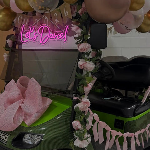 Lets Dance Neon Sign Pink LED Word Light for Weddings and Parties on decorated golf cart with balloons and flowers
