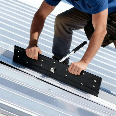 Worker using 16 Inch Heavy Duty Steel Folding Bender for sheet metal HVAC duct and roofing panel forming, creating precise folds.