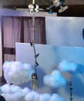 Pro Grade Stop Motion Armature Kit With Two Way Rail System For Vertical And Horizontal Movement, Stainless Steel Rig Arm For Figures And Models, Includes Five Connectors For Flexible, Dope Animation Setups, holding a figure over cloud backdrop