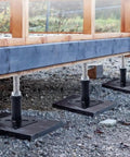 4 Pack Adjustable Floor Jack Posts No Sweat Heavy Duty Lift Supports 6 To 9 Inch Screw Jack supporting a wooden structure.