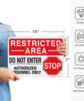 Step Up Site Security With Heavy Duty Reflective Aluminum Warning Signs 14x10 inch sign held by person, showing Restricted Area.